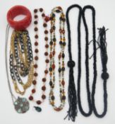 A collection of costume jewellery. Including an agate bead statement bracelet, an Art Deco black