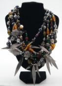 A Vintage six strand Givenchy, Paris glass bead, metal pierced beads and metal leaves statement