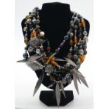 A Vintage six strand Givenchy, Paris glass bead, metal pierced beads and metal leaves statement