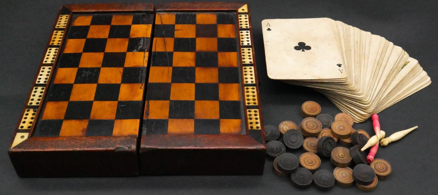 A Victorian inlaid wood and ivory travelling draughts/cribbage game board, with a pack of cards,