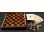 A Victorian inlaid wood and ivory travelling draughts/cribbage game board, with a pack of cards,