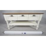 A small painted dresser with planked top above drawers on turned supports united by an under tier.