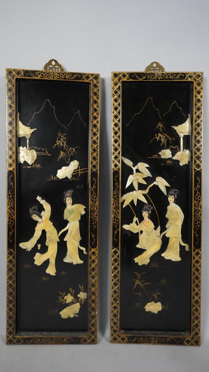 Two vintage Japanese lacquered wooden plaques with gilded borders, mounted with bone and mother of