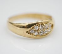 A Victorian 18 carat yellow gold and diamond ring. Set with nine cushion shaped old mine diamonds in