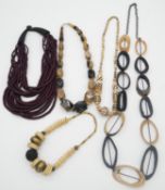 A collection of horn and bone necklaces. Including a vintage faceted horn graduated bead necklace, a