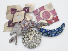 Five statement brooches. Including metal enamelled bespoke made brooches, one of a fish eating a
