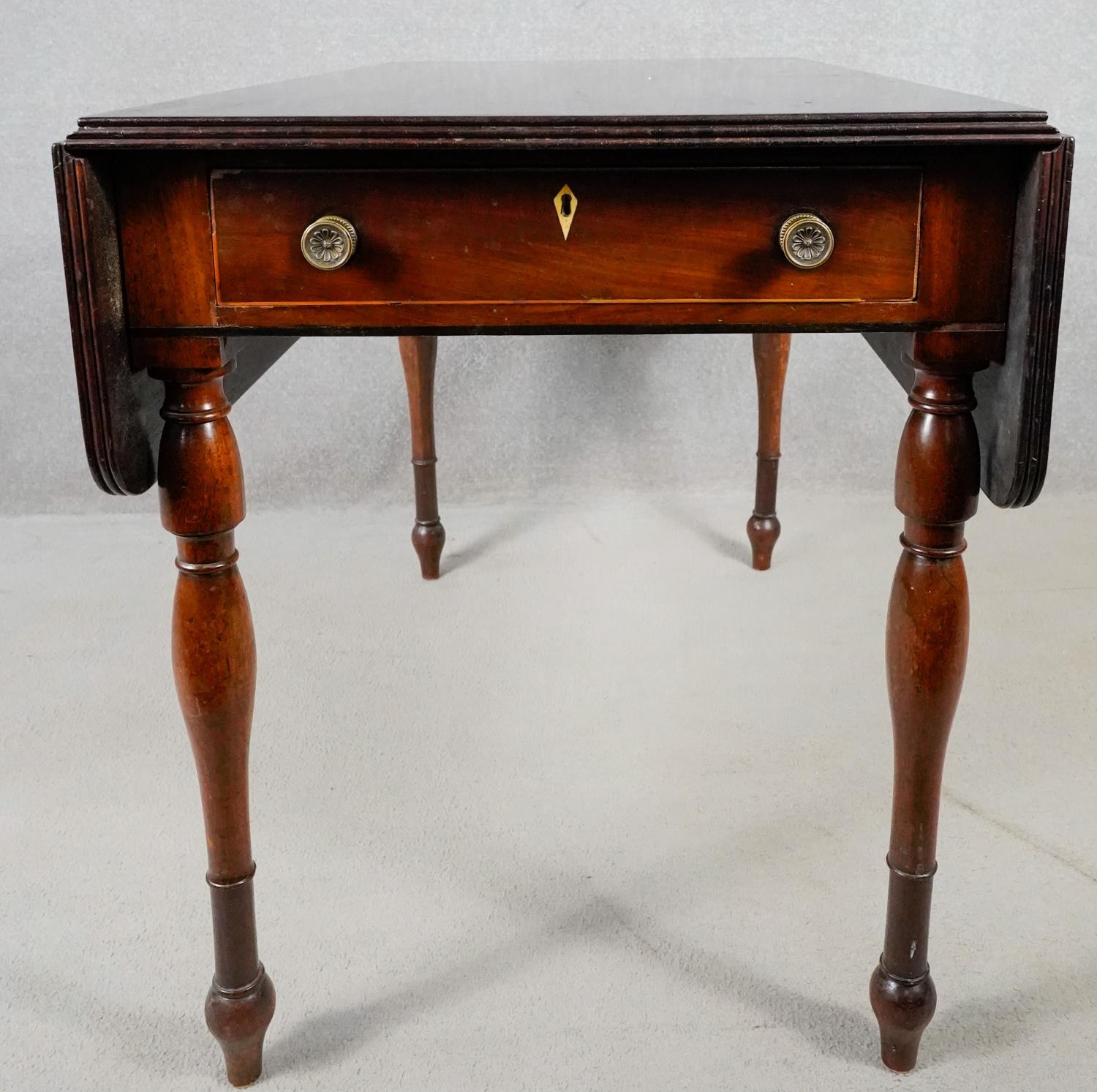 A 19th century mahogany drop flap Pembroke table with frieze drawer on turned tapering supports. H.