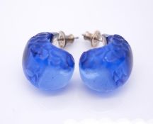 A pair of Lalique blue crystal J-hoop earrings with carved design and silver posts and