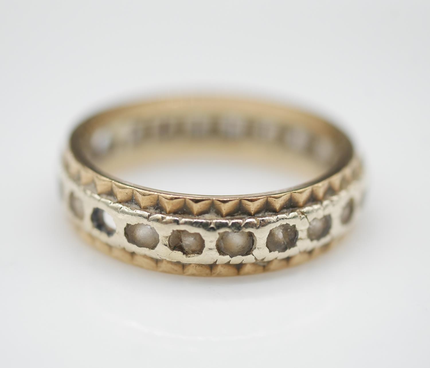 A yellow metal paste set (tested as gold) full eternity ring set with twenty two round old cut white