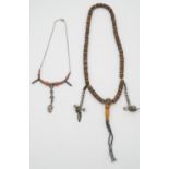 Two Oriental necklaces. One set of prayer beads, comprised of bone beads inlaid with coral and