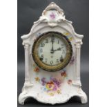 An Ansonia porcelain mantel clock with enamel dial and black Roman numerals, decorated with floral