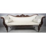 A William IV mahogany framed double scroll end sofa with palmette and acanthus carved back rail