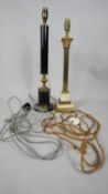 Two vintage Corinthian column design table lamps. One with a black laquered metal stem with gilded