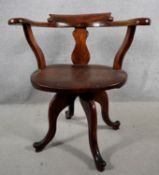 A 19th century elm seated revolving desk armchair on quadruped cabriole supports. H.78 W.57 D.50
