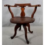 A 19th century elm seated revolving desk armchair on quadruped cabriole supports. H.78 W.57 D.50