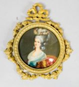 A gilt metal framed miniature on panel of a lady in formal dress, the frame decorated with