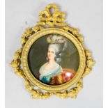 A gilt metal framed miniature on panel of a lady in formal dress, the frame decorated with