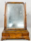 A mid Georgian walnut and carved giltwood toilet mirror with original plate and three frieze drawers