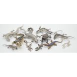 A collection of reptile and amphibian jewellery. Including seven lizard brooches, some silver, a