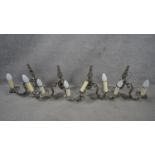 A set of four metal twin sconce wall candelabras with scrolling foliate arms. H.31 W.29