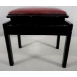 An adjustable black lacquered piano stool in leather upholstery stamped John Austin Furniture to the