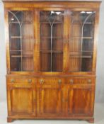 A Georgian style mahogany library bookcase with astragal glazed upper section above drawers and