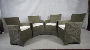 A set of four woven tub garden armchairs with fitted seat cushions. H.91 W.63 D.51