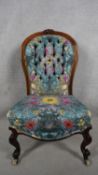 A Victorian carved oak framed nursing chair in newly upholstered deep buttoned William Clark