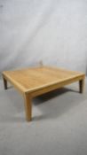 A contemporary light oak low table on square tapering supports. H.31 W.90 D.90