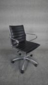 A Charles and Ray Eames inspired desk chair with revolving and tilting action in ribbed black