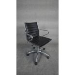 A Charles and Ray Eames inspired desk chair with revolving and tilting action in ribbed black