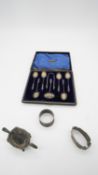 A cased set of silver apostle spoons and sugar tongs along with a silver salt and two silver