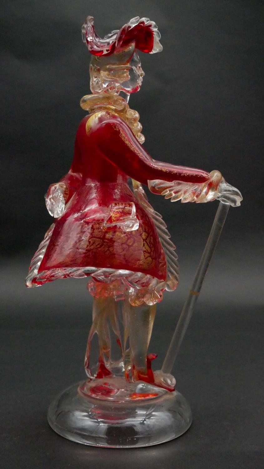 A vintage Murano gold flecked red glass figure of a Venetian gentleman with cane, on a clear round - Image 2 of 5