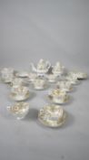 A C.1900 gilded and hand painted floral and foliate design porcelain tea set. Including a teapot,