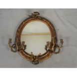 A 19th century gilt framed girandole with ribbon cresting and twin Rococo scrolling branches each