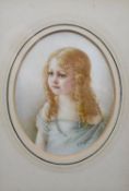 A 19th century framed and glazed miniature on ivory of a little girl with blonde hair and