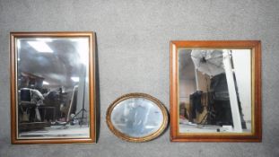 Three mirrors. Including an oval gilt framed Victorian style wall mirror, an antique veneered wall