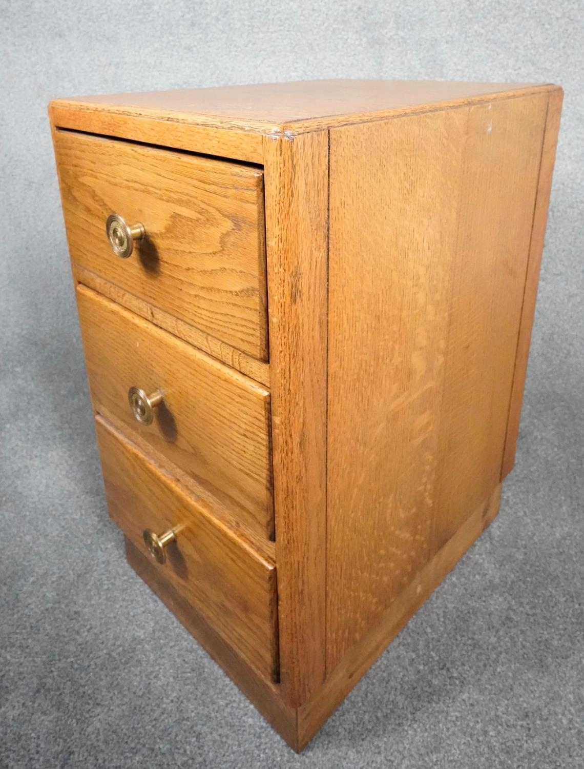 A mid century light oak three drawer pedestal chest on plinth base. H.63 W.35 D.46 - Image 6 of 7