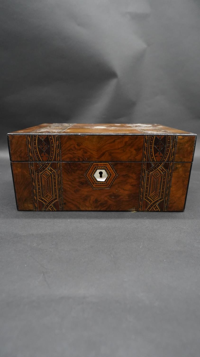 A Victorian burr walnut fitted jewellery box with marquetry and mother of pearl inlay with purple