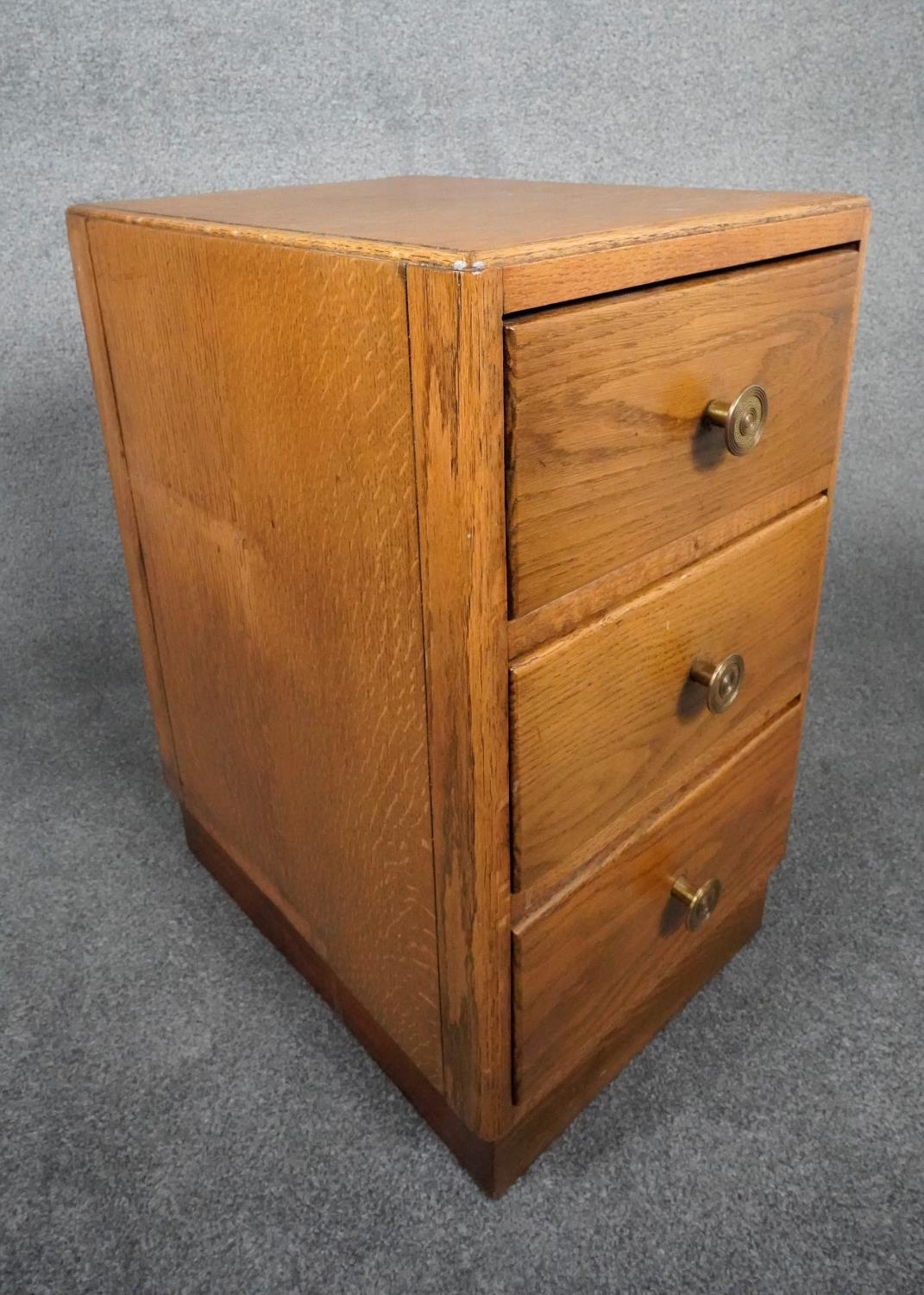 A mid century light oak three drawer pedestal chest on plinth base. H.63 W.35 D.46 - Image 2 of 7