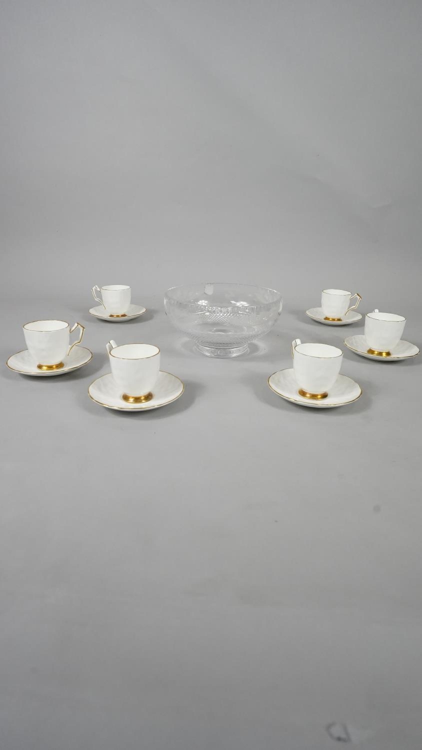 A set of six Aynsley porcelain gilded tea cups and saucers along with a boxed Edinburgh crystal