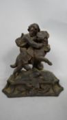 A late 19thC Black Forest carved limewood group, a young boy clinging to the back of a St Bernard