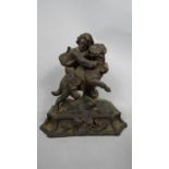 A late 19thC Black Forest carved limewood group, a young boy clinging to the back of a St Bernard