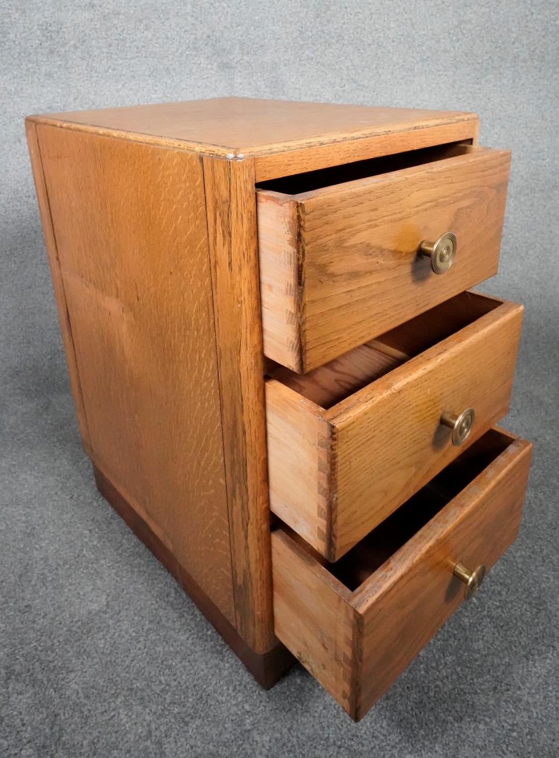 A mid century light oak three drawer pedestal chest on plinth base. H.63 W.35 D.46 - Image 3 of 7