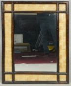 A wall mirror in a bamboo and woven rattan frame. H.98 W.78cm