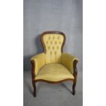 A Victorian style mahogany framed armchair in deep buttoned leather upholstery. H.104