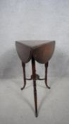 A late Victorian mahogany trefoil shaped drop flap occasional table on swept stretchered supports.