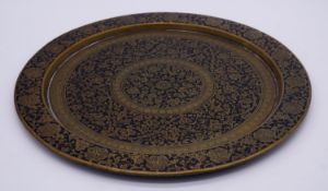 An antique Indian brass and black enamel platter. Engraved with a stylised floral and foliate