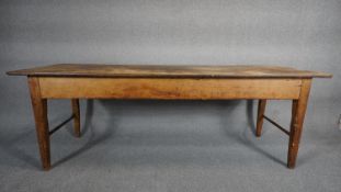 A 19th century pine refectory dining table with planked top on square tapering stretchered end