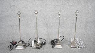 Four Contemporary chrome table lamps with square bases. H.50 W.15